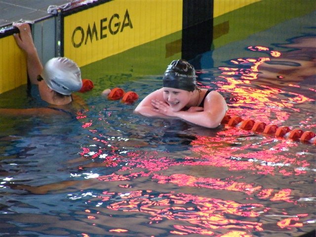 Martina, ancora in acqua,  sorridente con le braccia appoggiate alla corsia, soddisfatta dopo la gara dei 100 rana